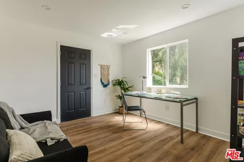 a backyard of a house with table and chairs