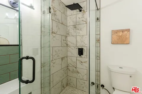 a view of backyard with outdoor seating and plants