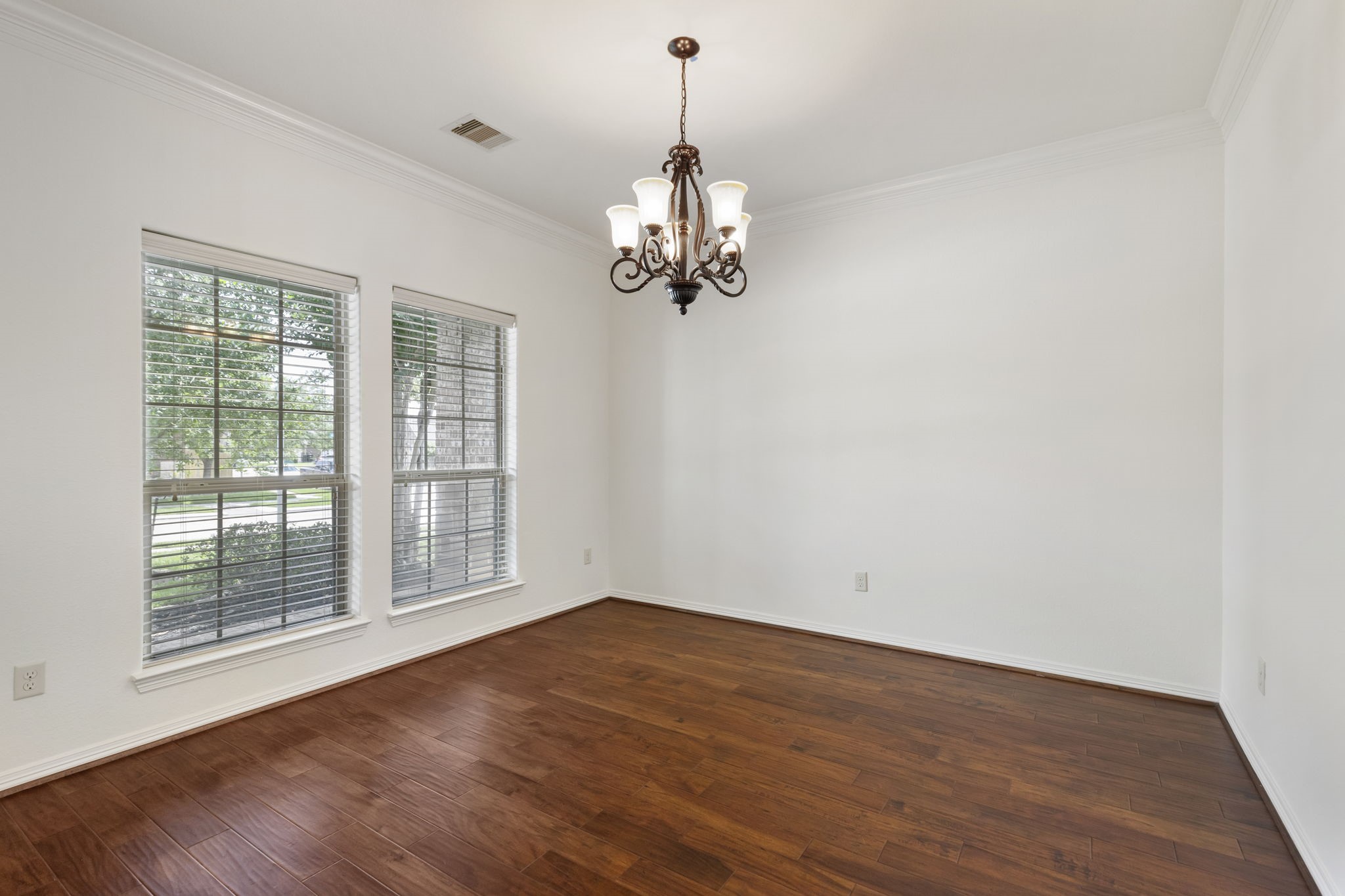23911 Augusta Falls Lane Spring, TX 77389 - Photo 5 of 40 a view of a room with wooden floor chandelier and windows
