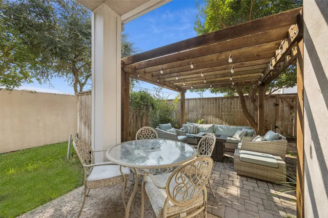 a view of a patio with table and chairs and potted plants
