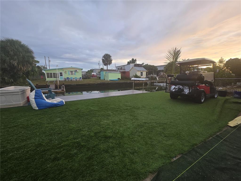 a view of a house with a yard and sitting area