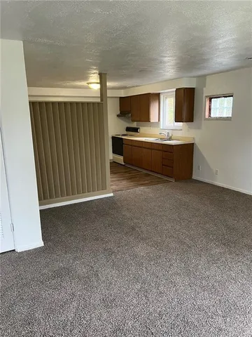 a living room with stainless steel appliances kitchen island furniture and a kitchen view