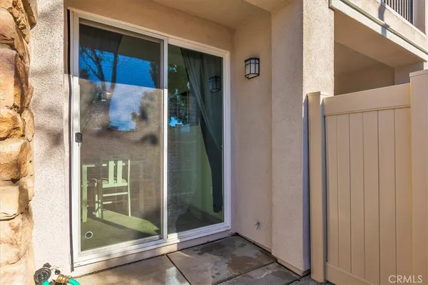 a kitchen with granite countertop a refrigerator stove and sink with wooden floor
