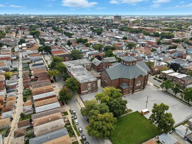 an aerial view of a house with garden space and street view
