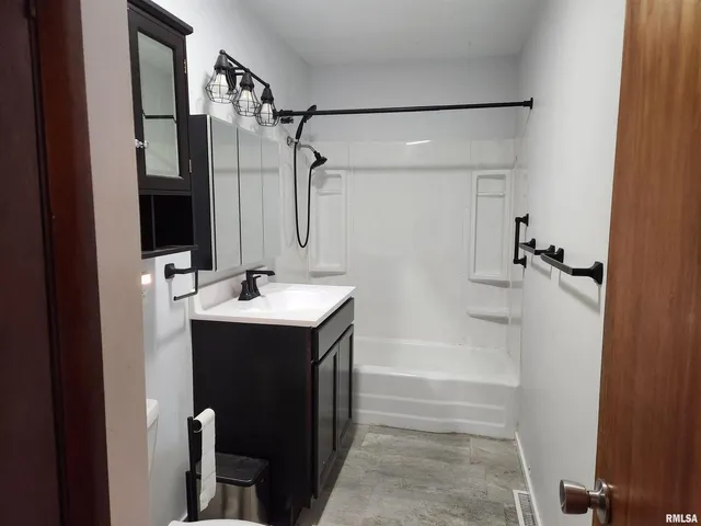 a bathroom with a sink a mirror and shower