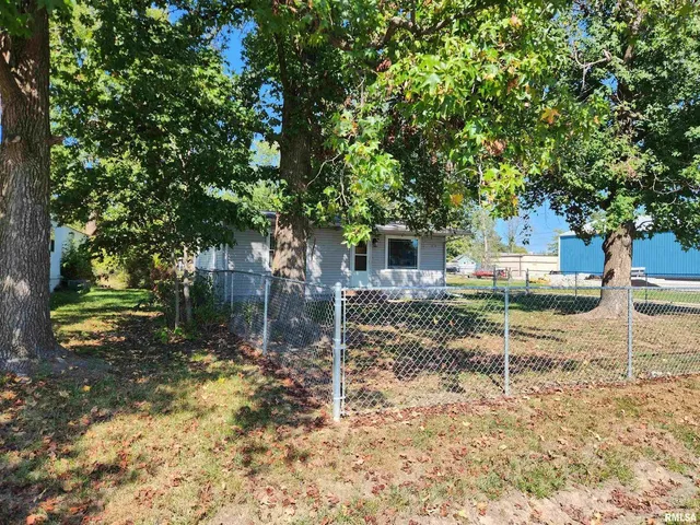 a view of a chair and table in backyard