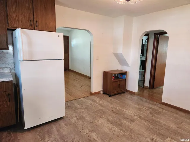 a view of a kitchen with refrigerator and a refrigerator