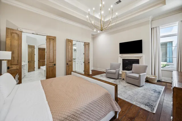 a bedroom with a bed couch and a flat screen tv