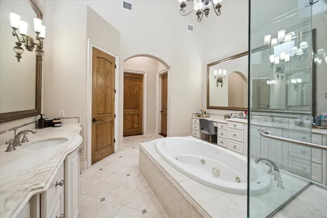 a spacious bathroom with a tub sink and mirror