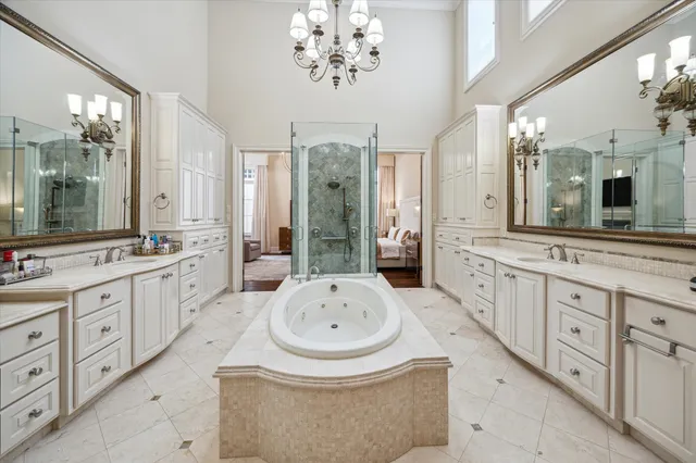 a bathroom with a granite countertop sink mirror and a bathtub