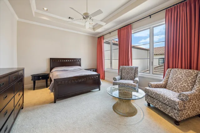 a bedroom with bed and a chandelier