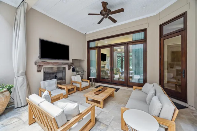 a living room with furniture a large window and a flat screen tv