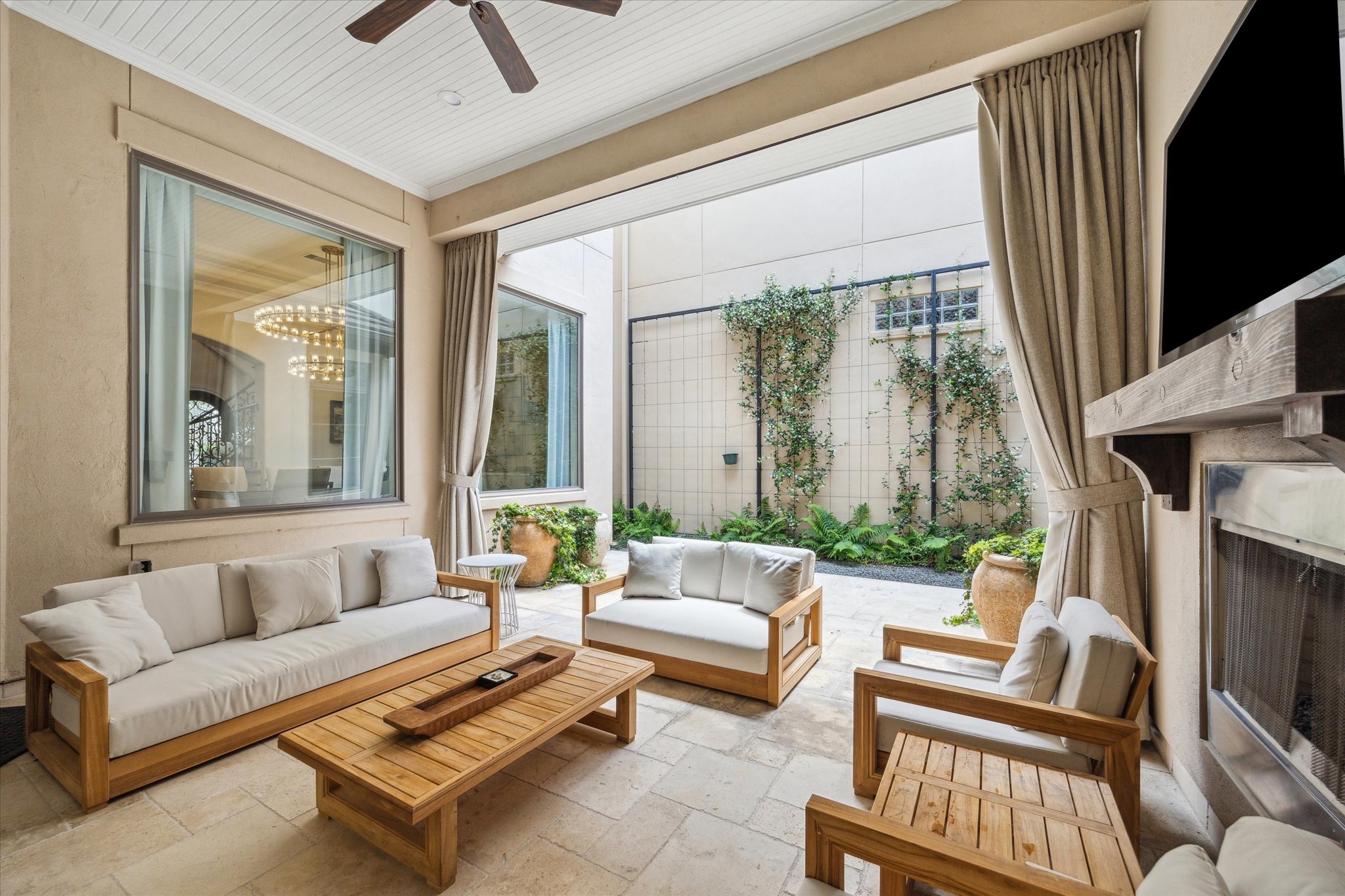 1110 Longmont Pl Court Houston, TX 77056 - Photo 30 of 35 a living room with furniture a large window and a flat screen tv
