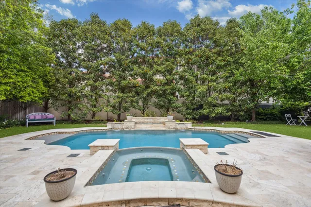 a swimming pool with outdoor seating and yard