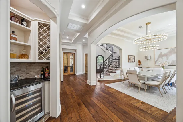 a view of a dining room with furniture wooden floor and chandelier