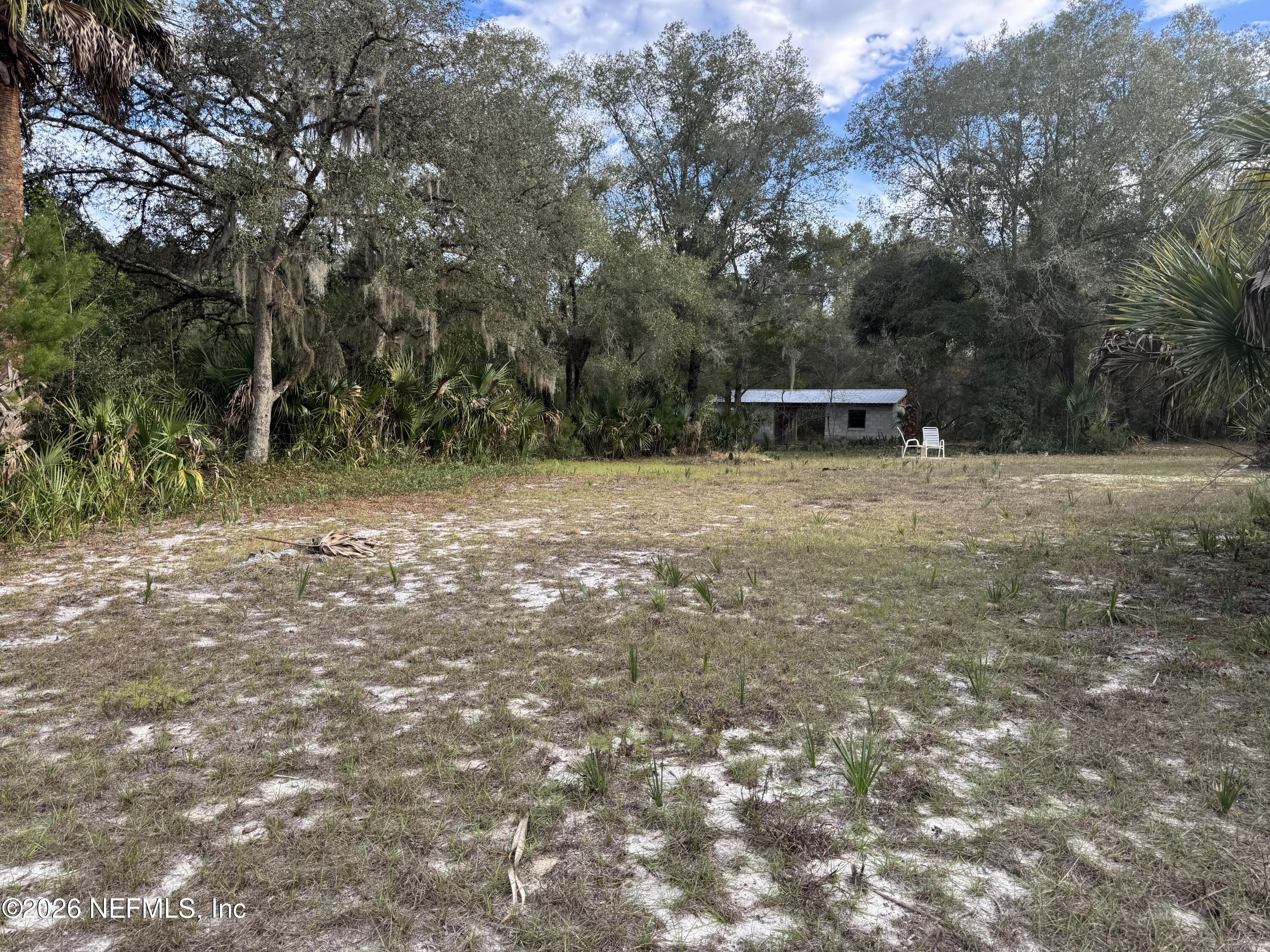 850 Cousintown Road Interlachen, FL 32148 - Photo 21 of 27 a backyard of a house with table and chairs