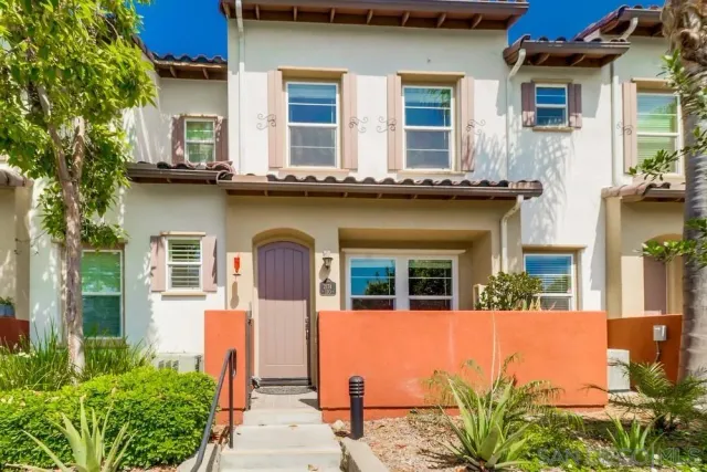 a front view of a building with a garden