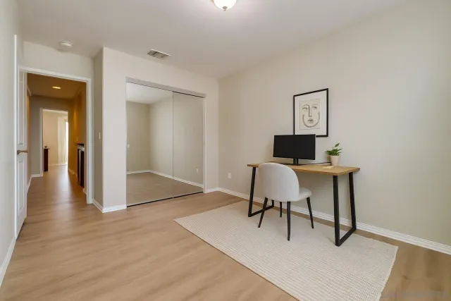 a view of a workspace with furniture and wooden floor