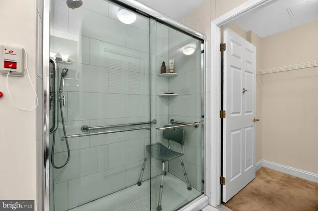 a bathroom with a shower and a glass door
