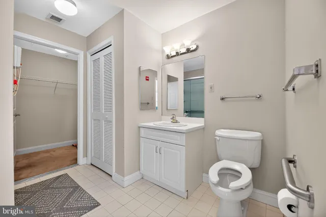 a bathroom with a toilet sink and shower