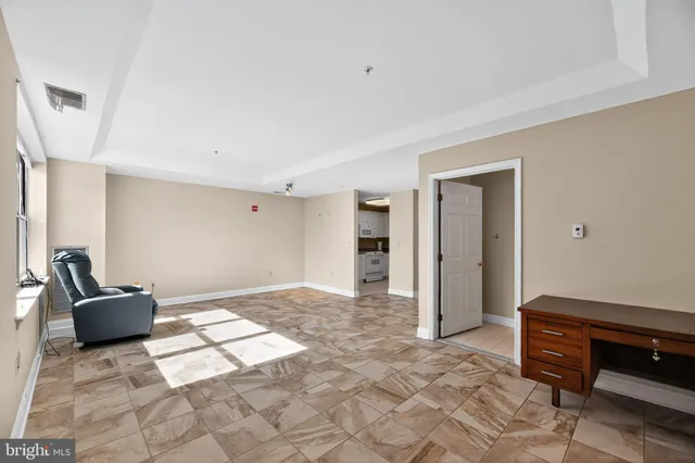 a view of a livingroom with wooden floor and furniture