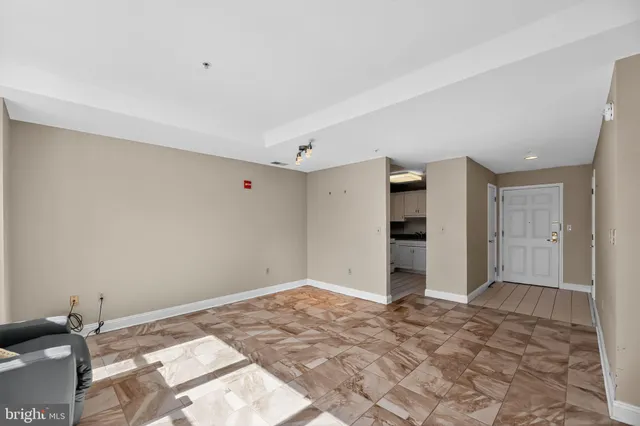a view of a livingroom with wooden floor and bedroom