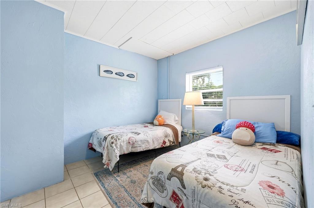 2347 Harbor Road Naples, FL 34104 - Photo 13 of 29 a bedroom with two beds and a window