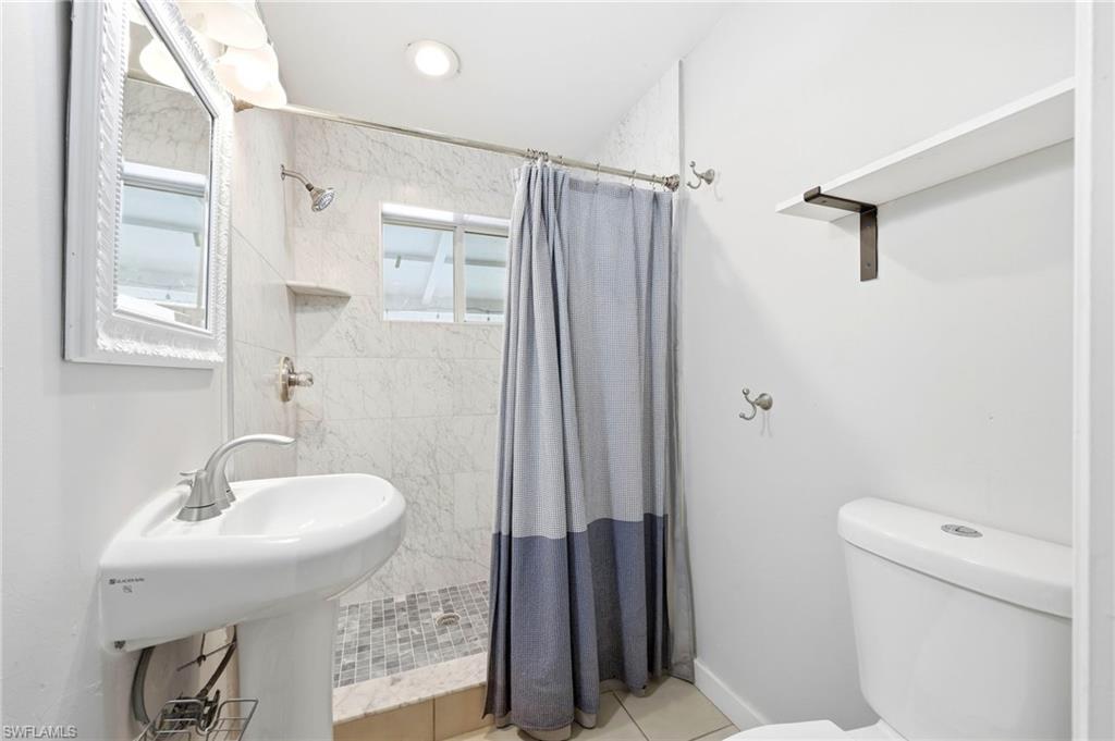 2347 Harbor Road Naples, FL 34104 - Photo 14 of 29 a bathroom with a sink toilet and shower