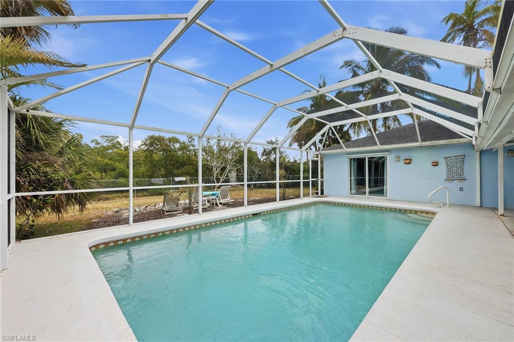 2347 Harbor Road Naples, FL 34104 - Photo 25 of 29 a view of a house with a swimming pool