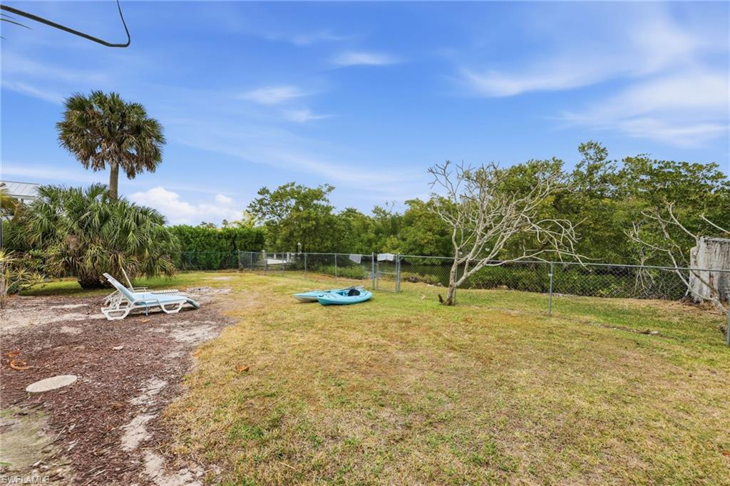 2347 Harbor Road Naples, FL 34104 - Photo 28 of 29 a view of a swimming pool with a yard