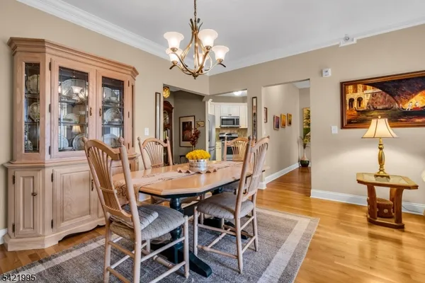 a view of a dining room with furniture wooden floor and chandelier