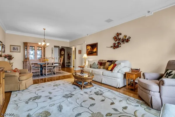 a living room with furniture a dining table and chairs with kitchen view