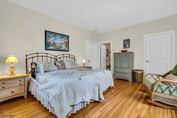 a bedroom with bed and two windows