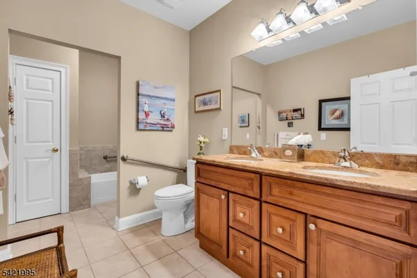 a spacious bathroom with a double vanity sink mirror and toilet