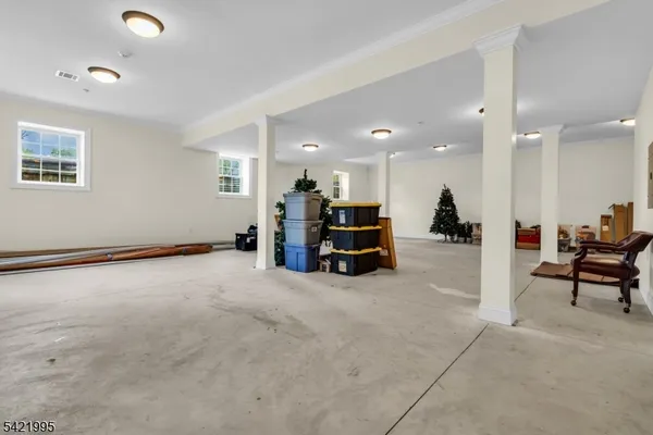 an empty room with furniture and a large window