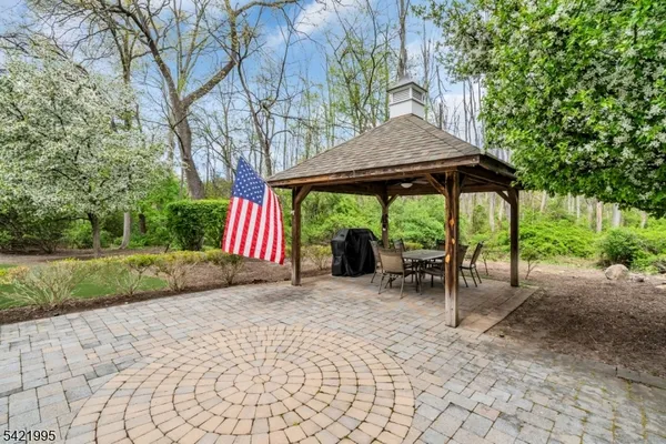 a view of patio with a table and chairs under an umbrella