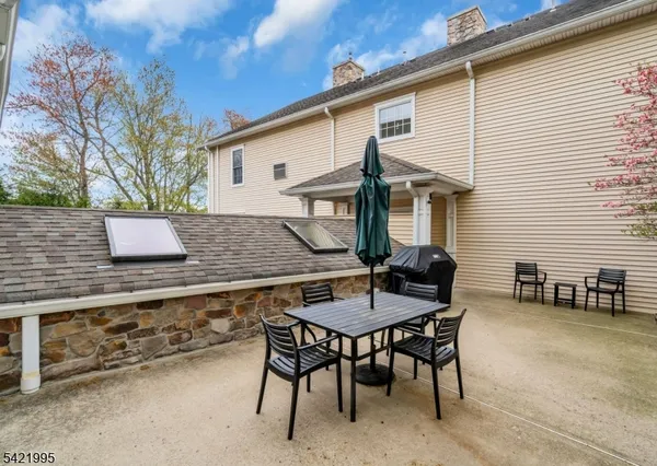 a view of house with backyard and sitting area