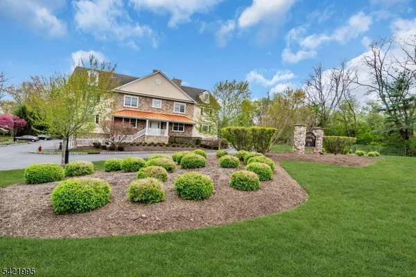 a front view of a house with a yard and outdoor seating