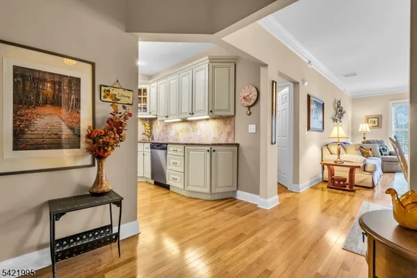 a living room with stainless steel appliances kitchen island granite countertop furniture and a livingroom view
