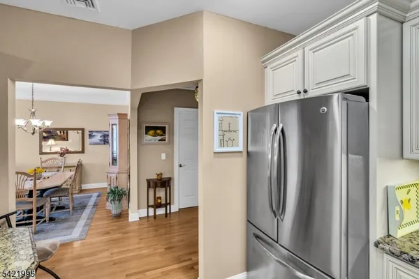 a kitchen with stainless steel appliances granite countertop a refrigerator and microwave
