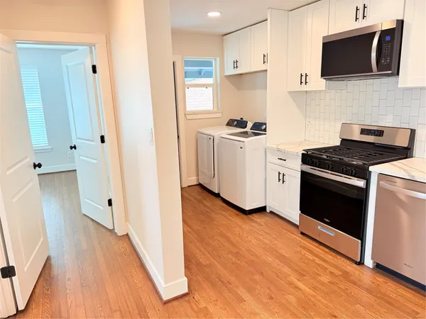 a kitchen with a microwave stove top oven and sink
