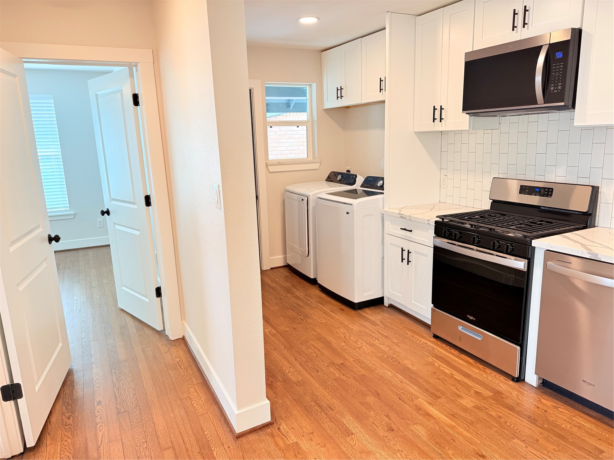 a kitchen with a microwave stove top oven and sink