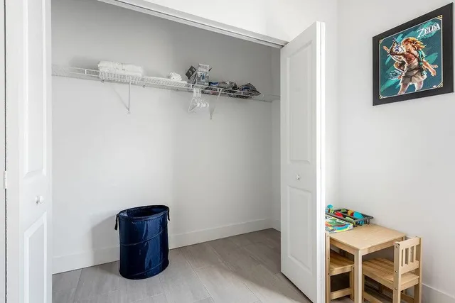 a bedroom with a bed and night stand