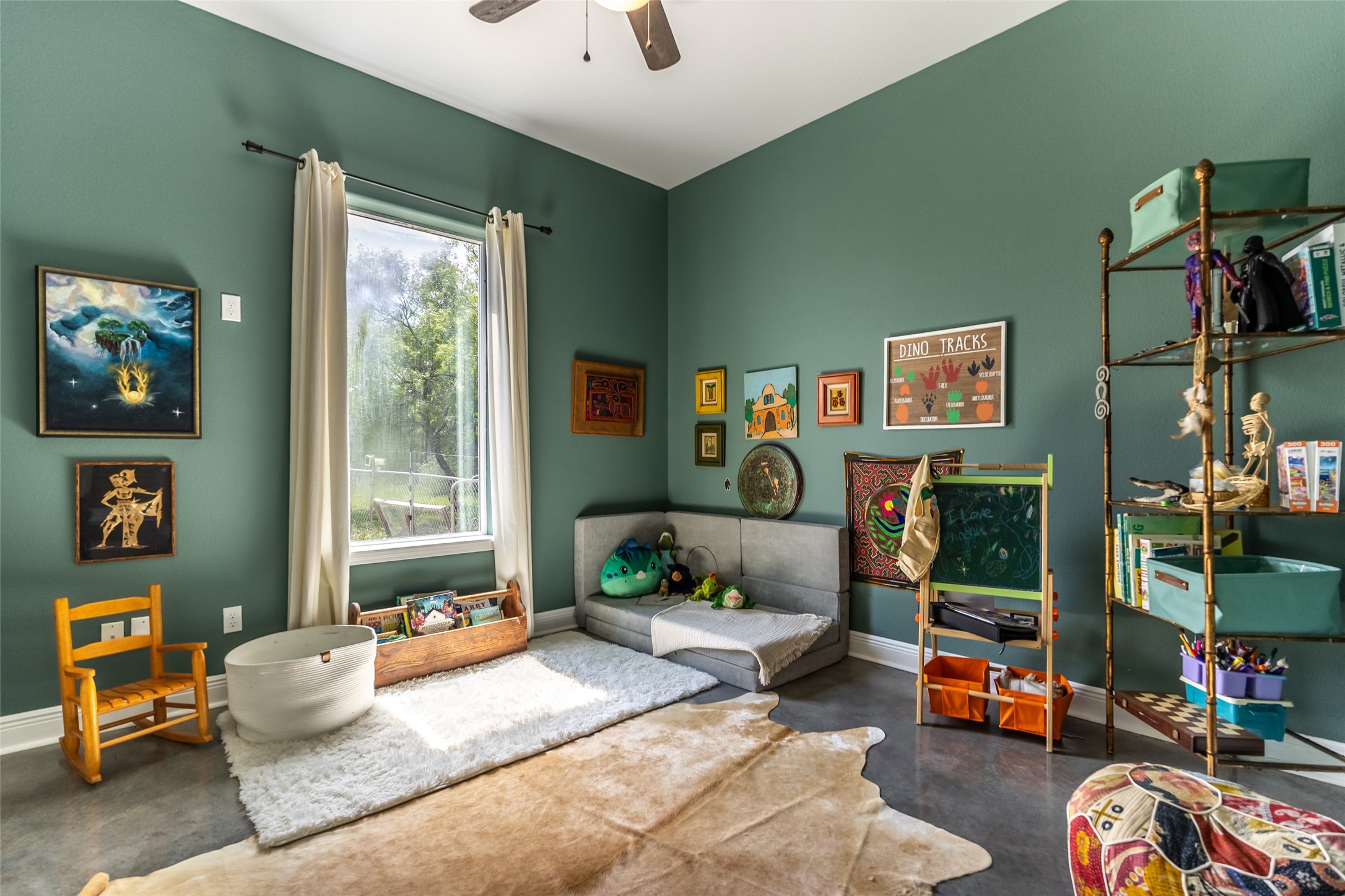 4082 Old Colony Line Road Lockhart, TX 78644 - Photo 10 of 40 A well-lit, verdant room with polished concrete flooring and ample space for creative endeavors.