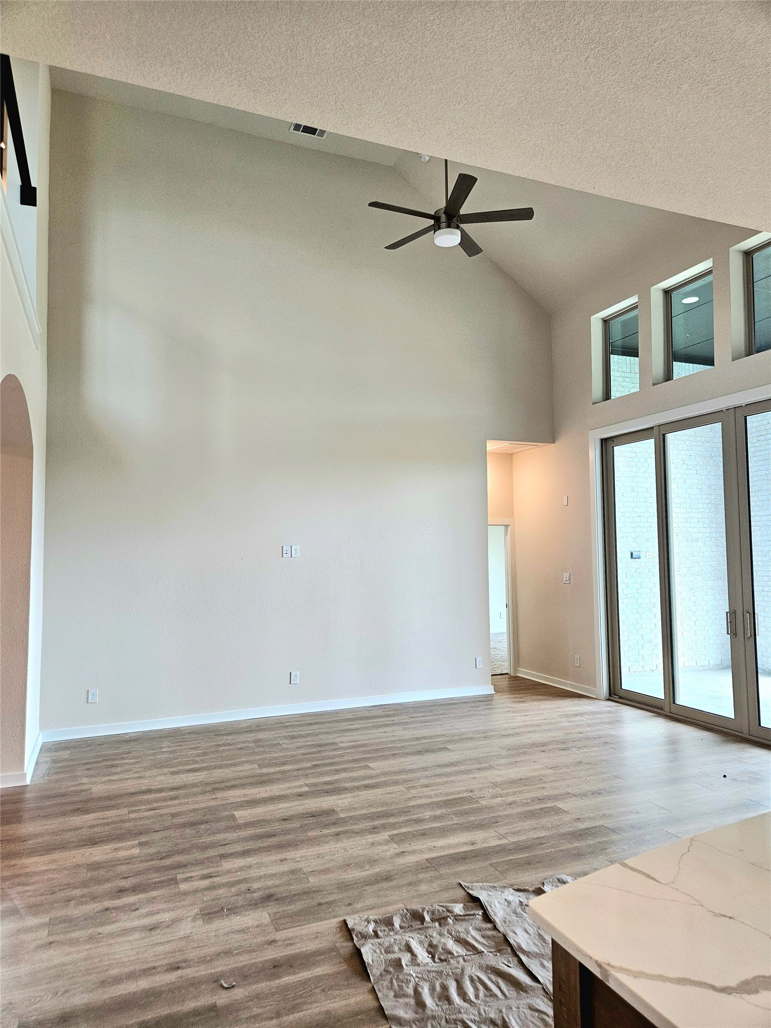 8701 Antelope Cyn Way Manvel, TX 77578 - Photo 9 of 32 a view of an empty room with wooden floor and a window