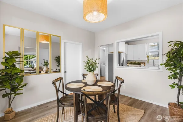 a dining room with furniture and wooden floor