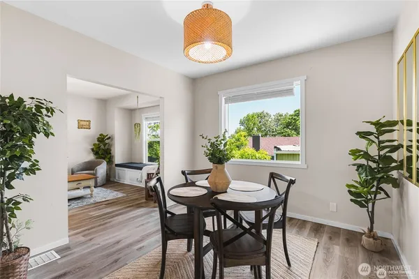 a view of a dining room with furniture window and wooden floor