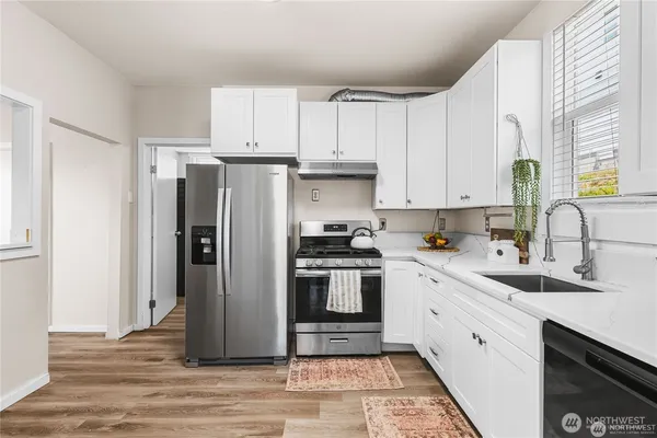 a kitchen with stainless steel appliances granite countertop a refrigerator sink and cabinets