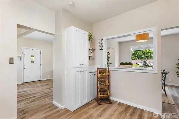 a view of walk in closet with window and wooden floor