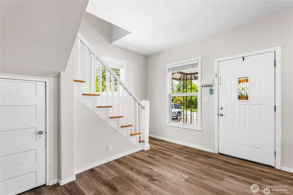 a view of an entryway with wooden floor and windows